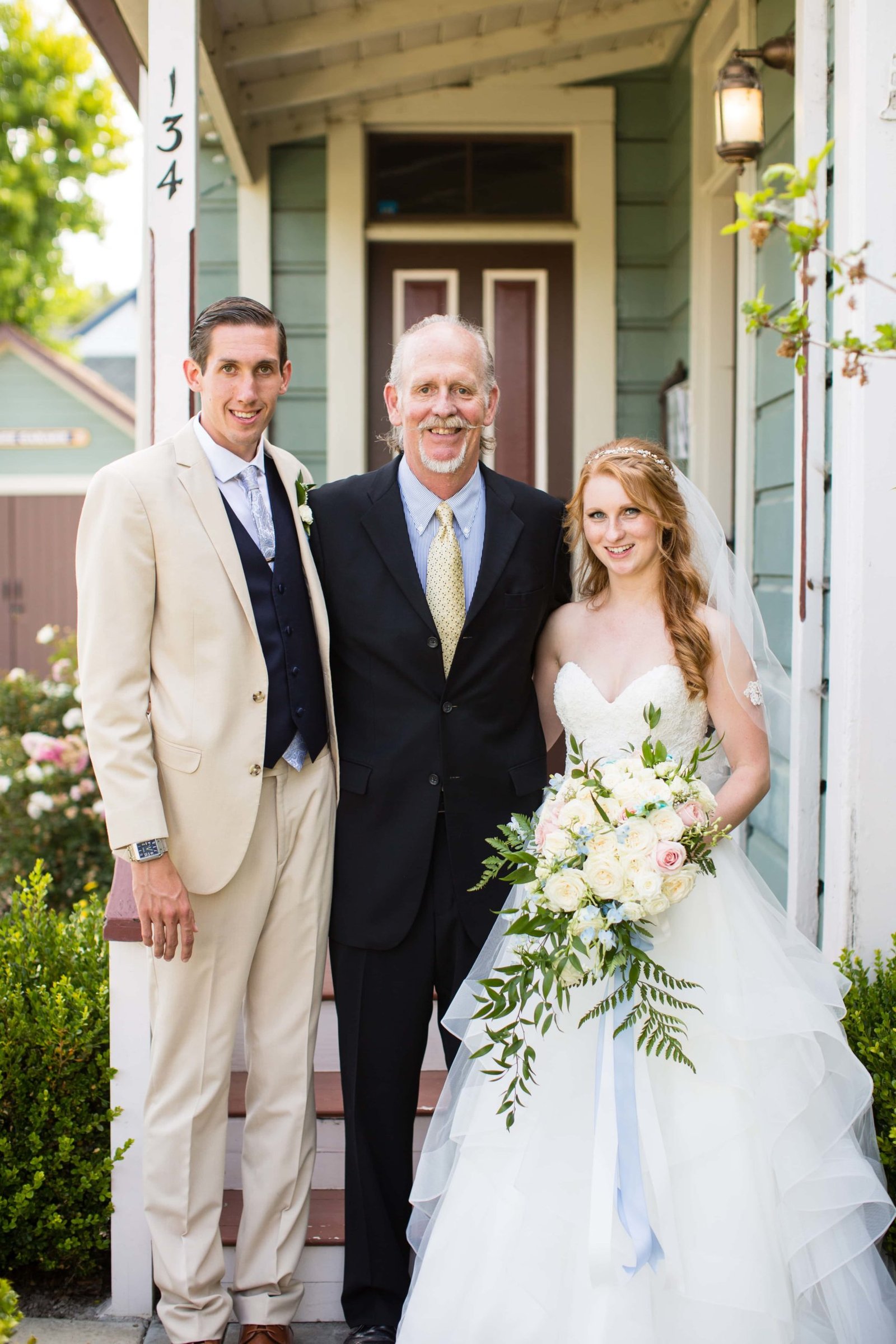 Bride and groom standing with officiant Tom Allen at Heritage House in Arroyo Grande