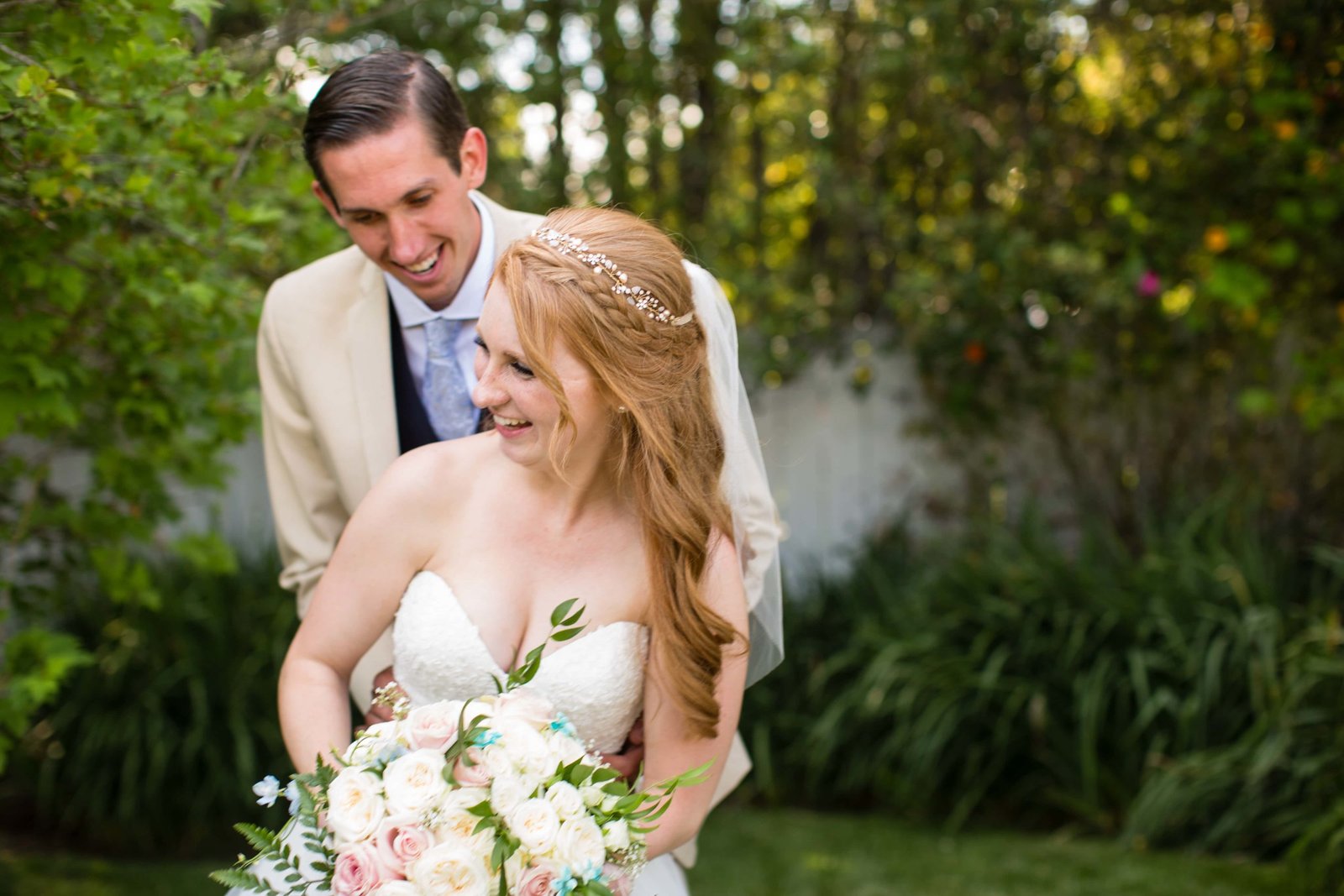Bride and groom laugh at Heritage House in Arroyo Grande