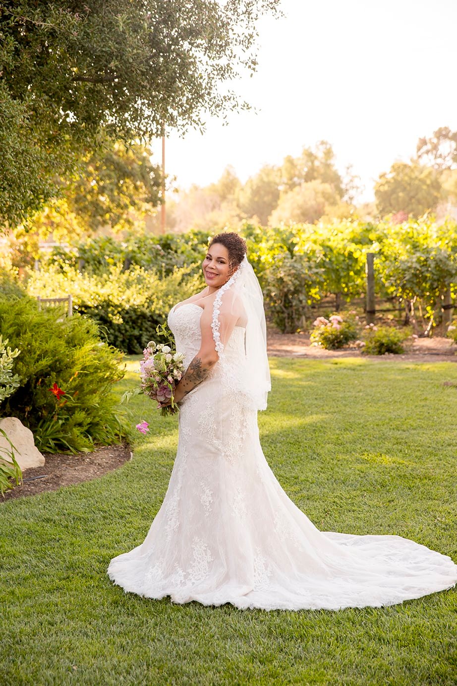 Bride poses on the lawn at Roblar Winery in Santa Ynez, CA