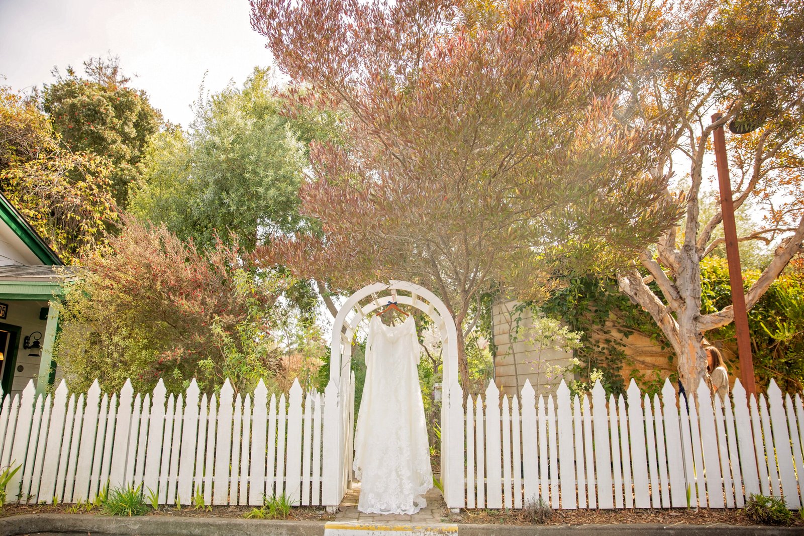wedding dress hanging from a gate at Cambria Pines Lodge