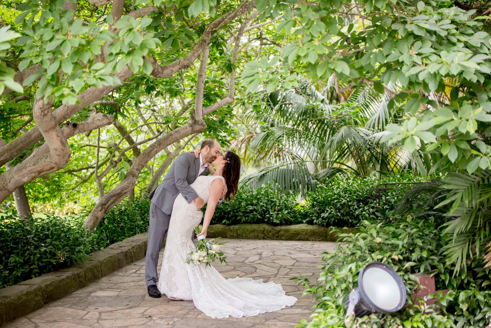 Bride and groom kiss under a tree at their Santa Barbara Courthouse wedding
