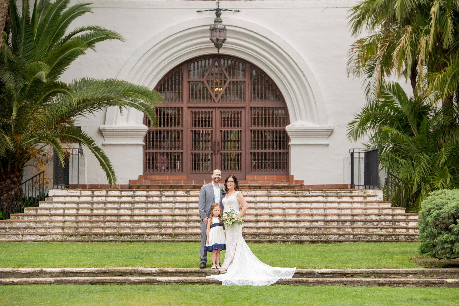 Bride and groom stand with flower girsl at the Santa Barbara Courthouse
