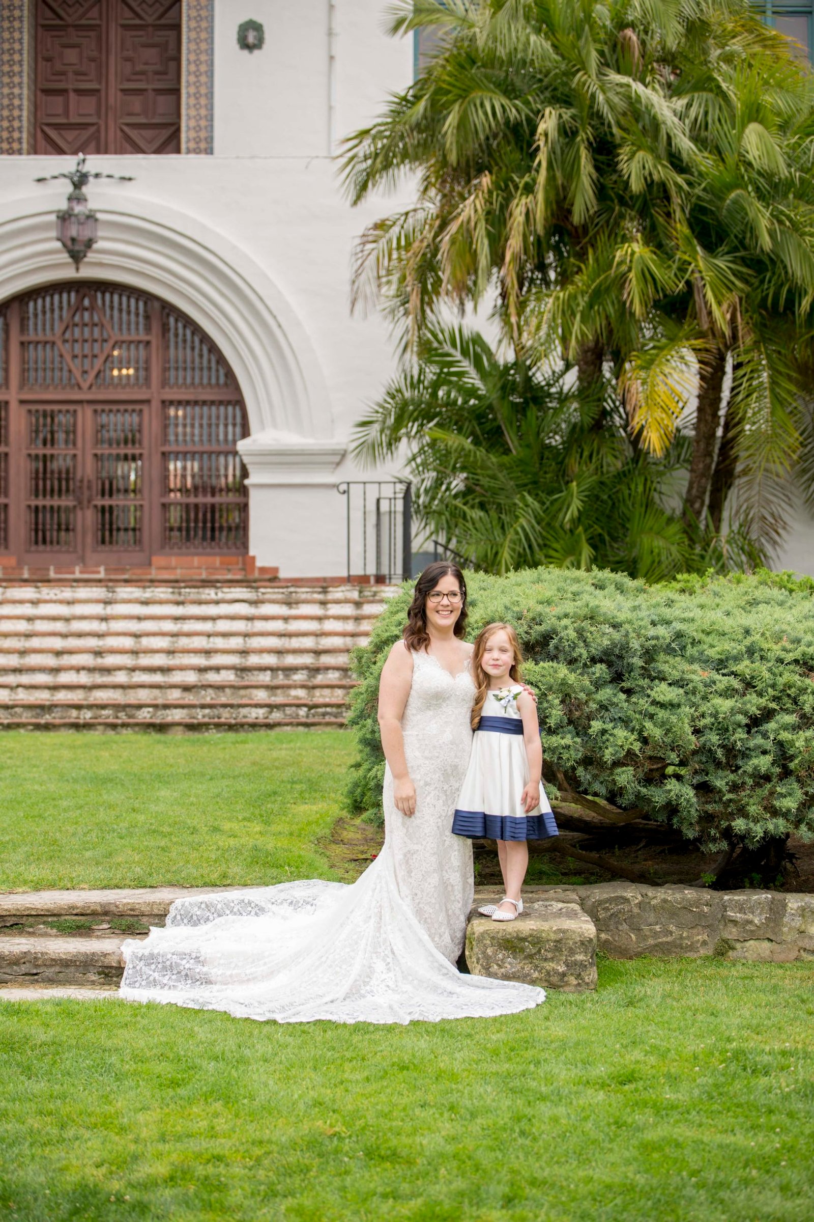 Bride with the flower girl on the steps at the Santa Barbara Courthouse
