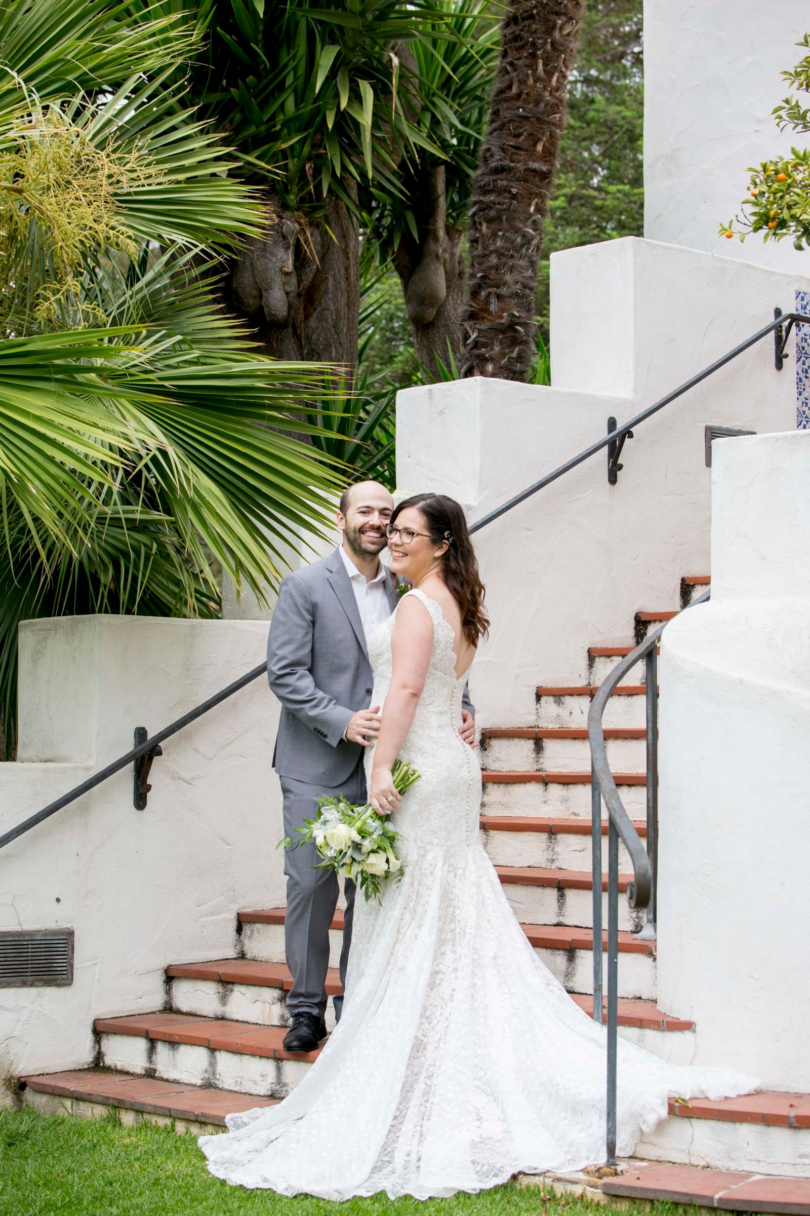 bride and groom pose at the Santa Barbara Courthouse