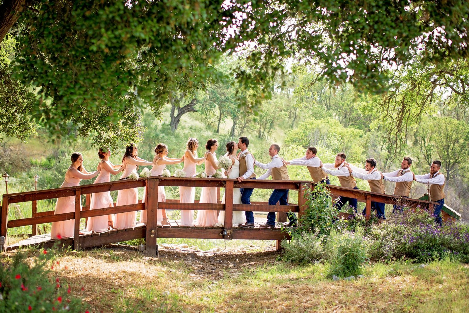 wedding party on a wood bridge