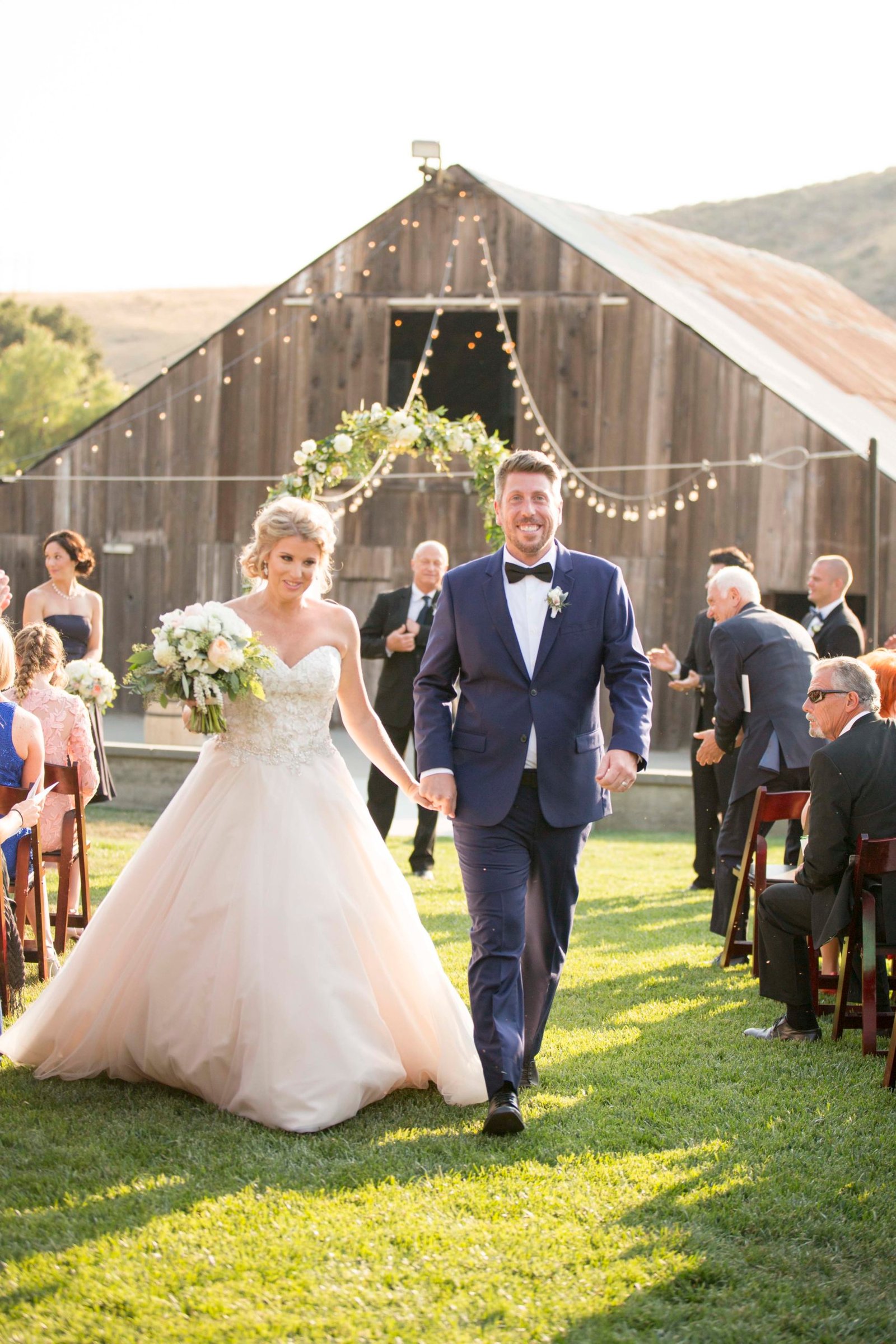 Bride and groom walking down the aisle after the ceremony at Higuera Ranch
