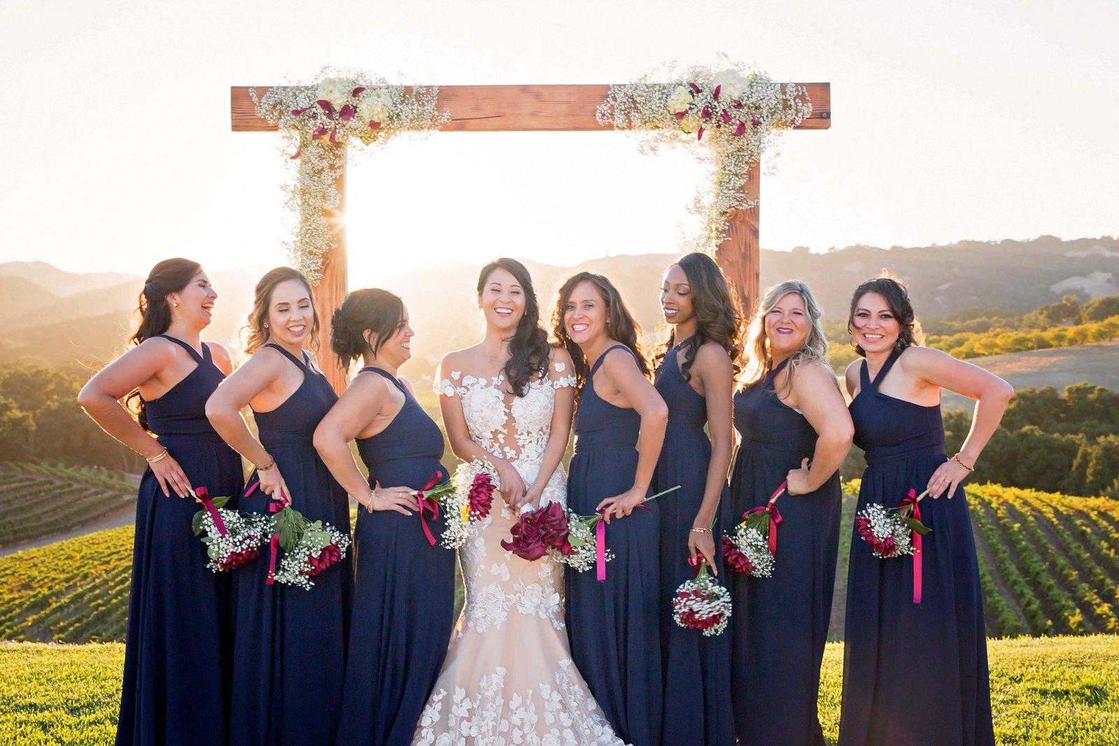 bride laughing with bridesmaids on the hill at Opolo