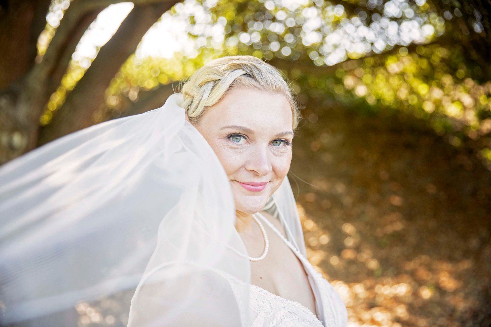 bride looking at the camera with her veil in the foreground
