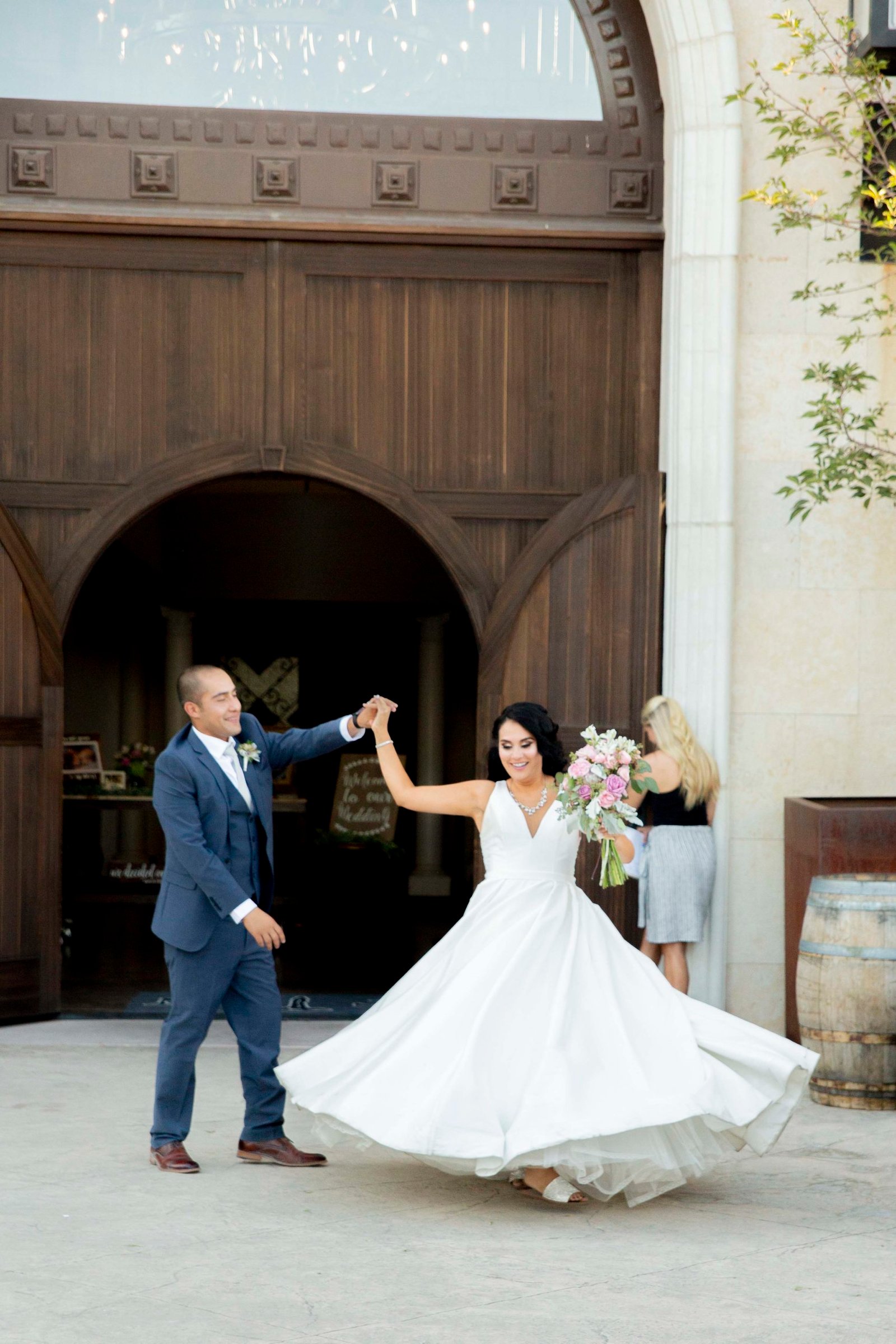 Groom twirls the bride during their grand entrance at Tooth and Nail Winery
