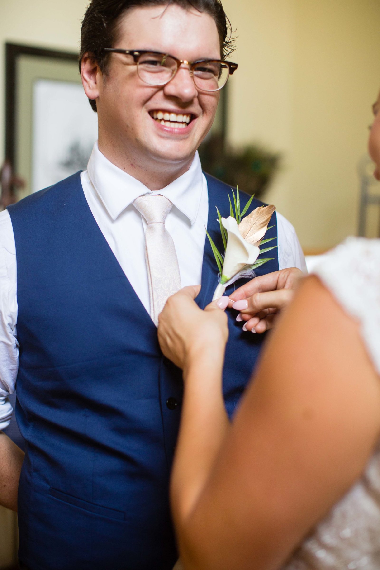 groom gets his boutonniere attached at The Monday Club