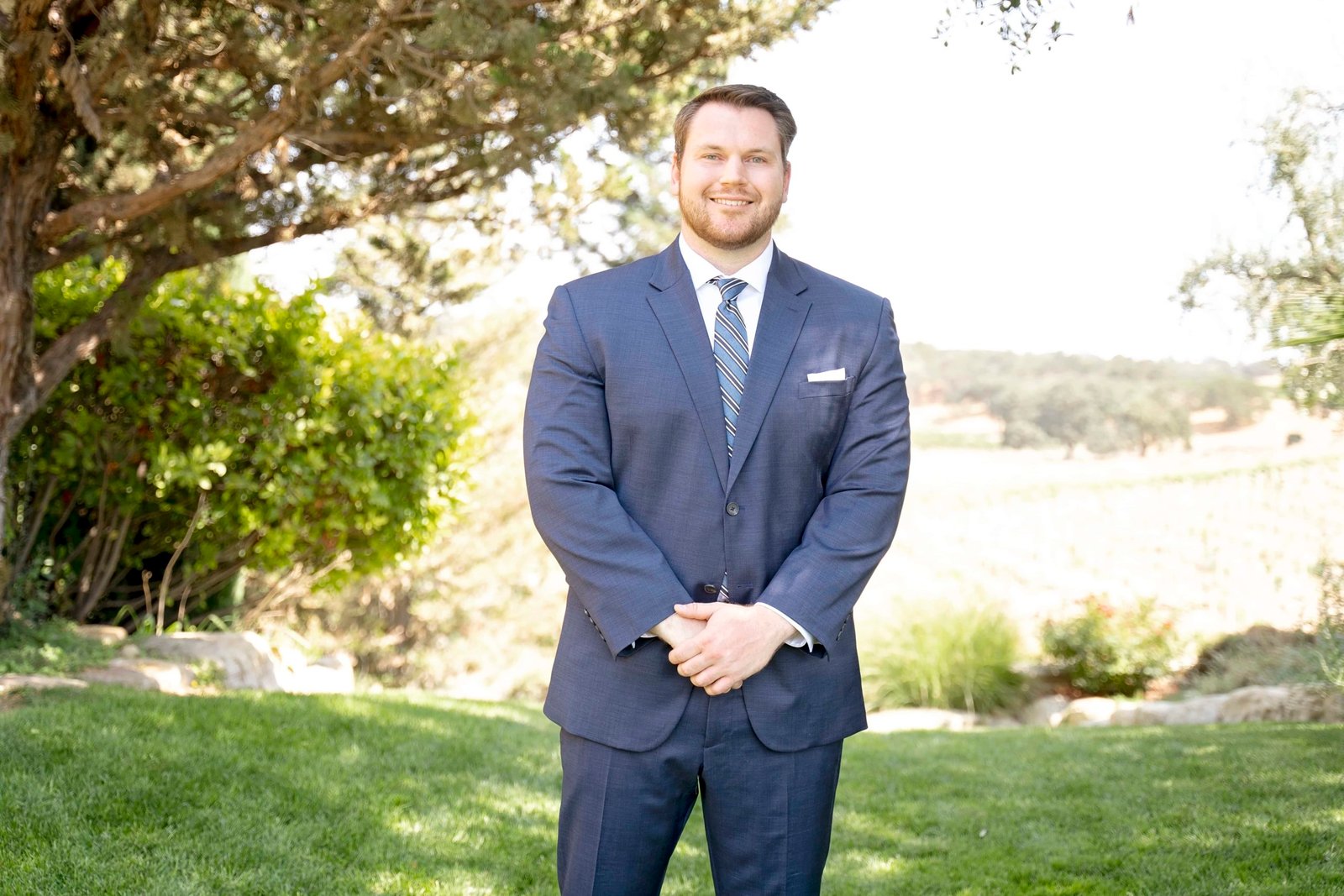 groom standing with hands crossed in front of him at CaliPaso Winery
