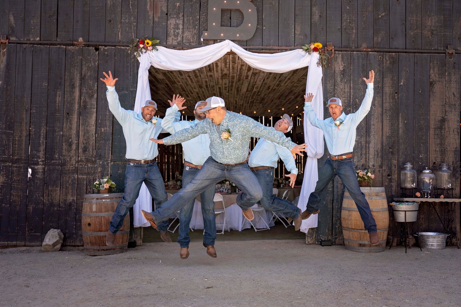 groom and groomsmen jumping