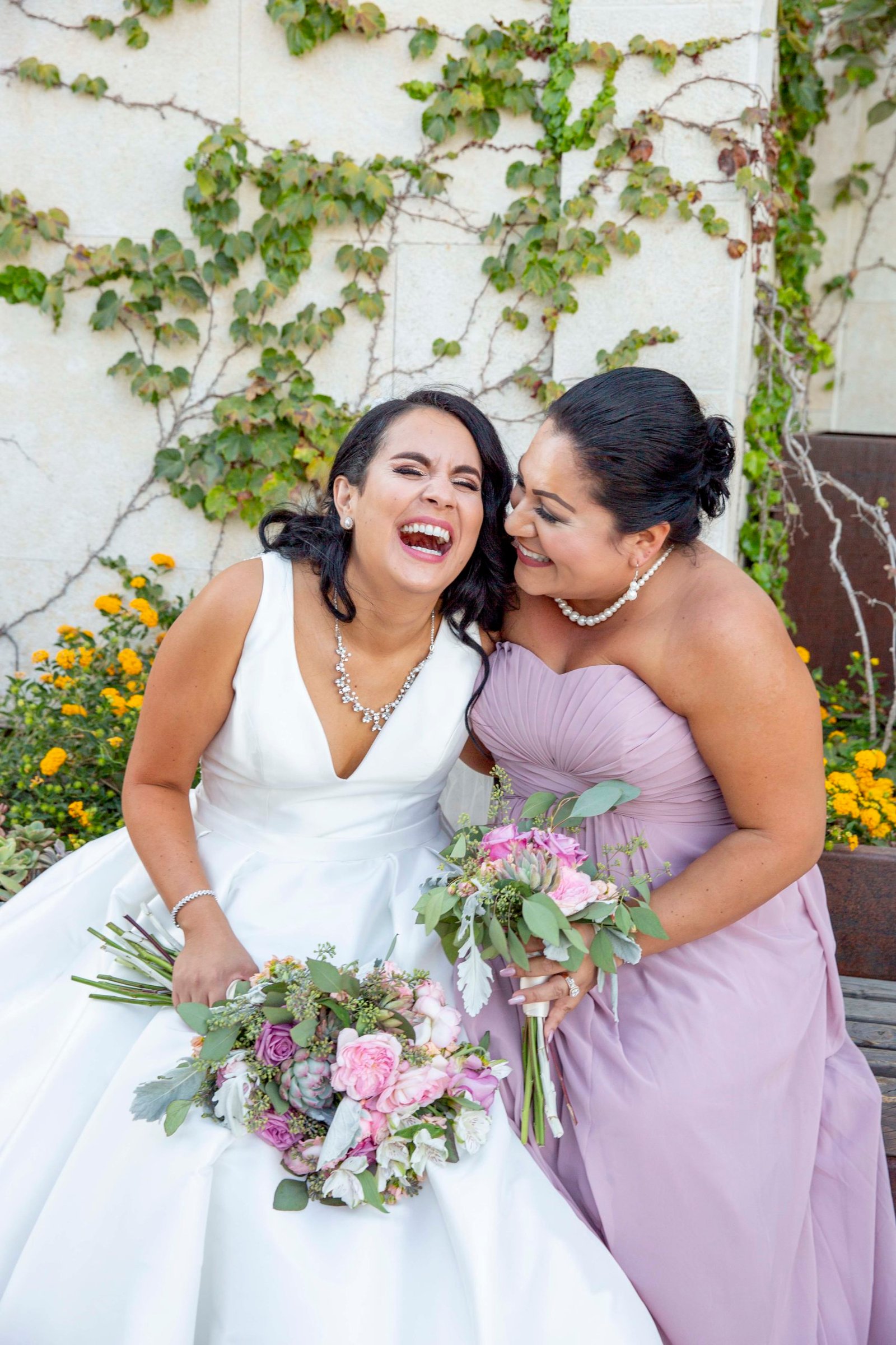 Bride laughing with a bridesmaid