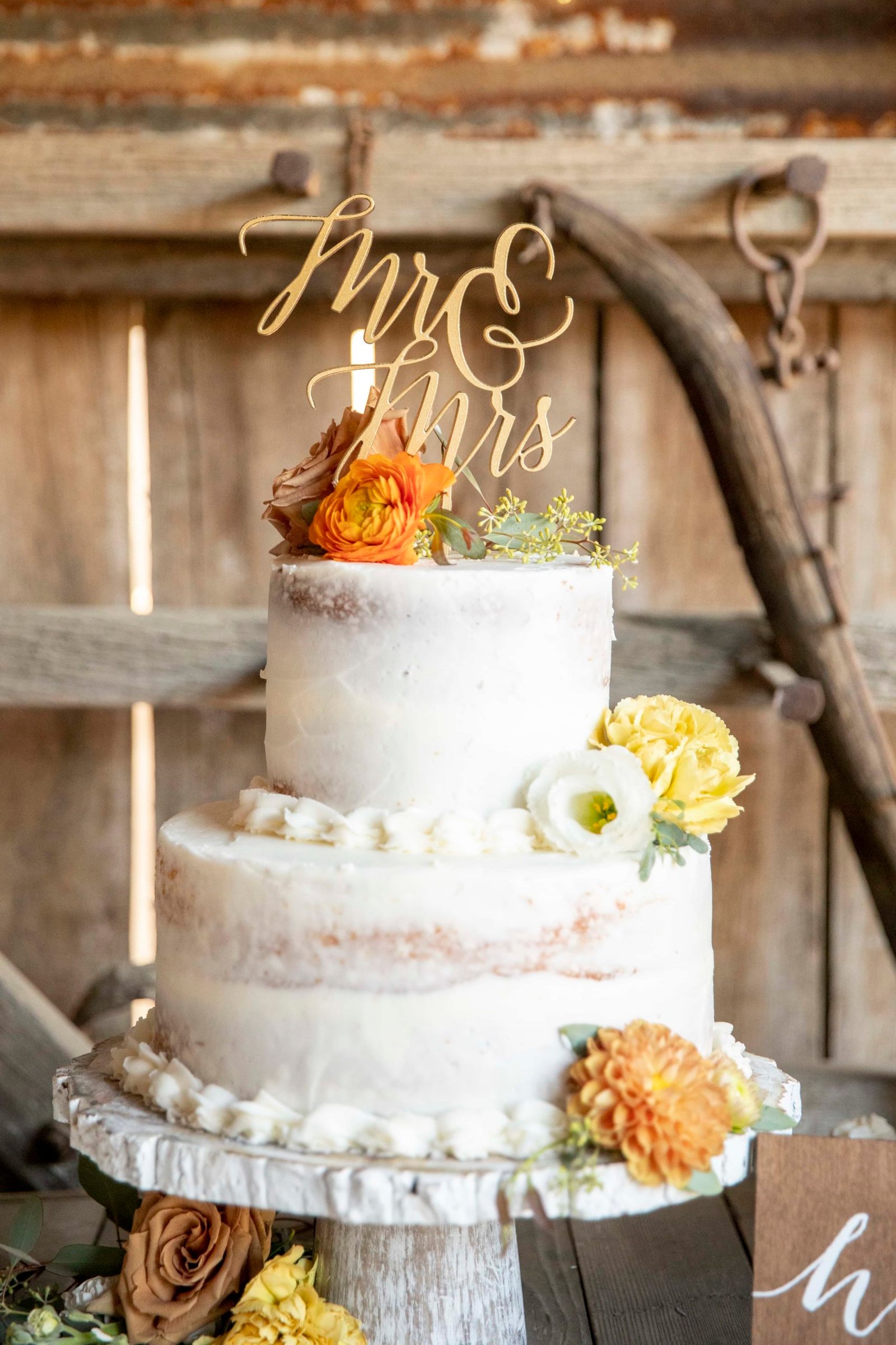 wedding cake with yellow and orange flowers
