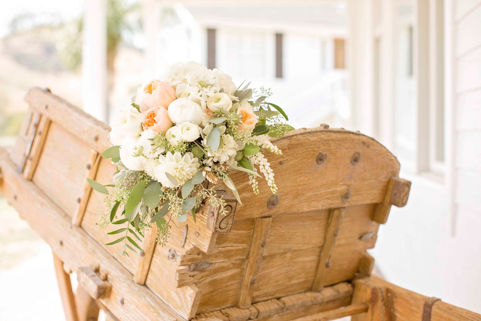 Wedding bouquet on a wood cart at Higuera Ranch