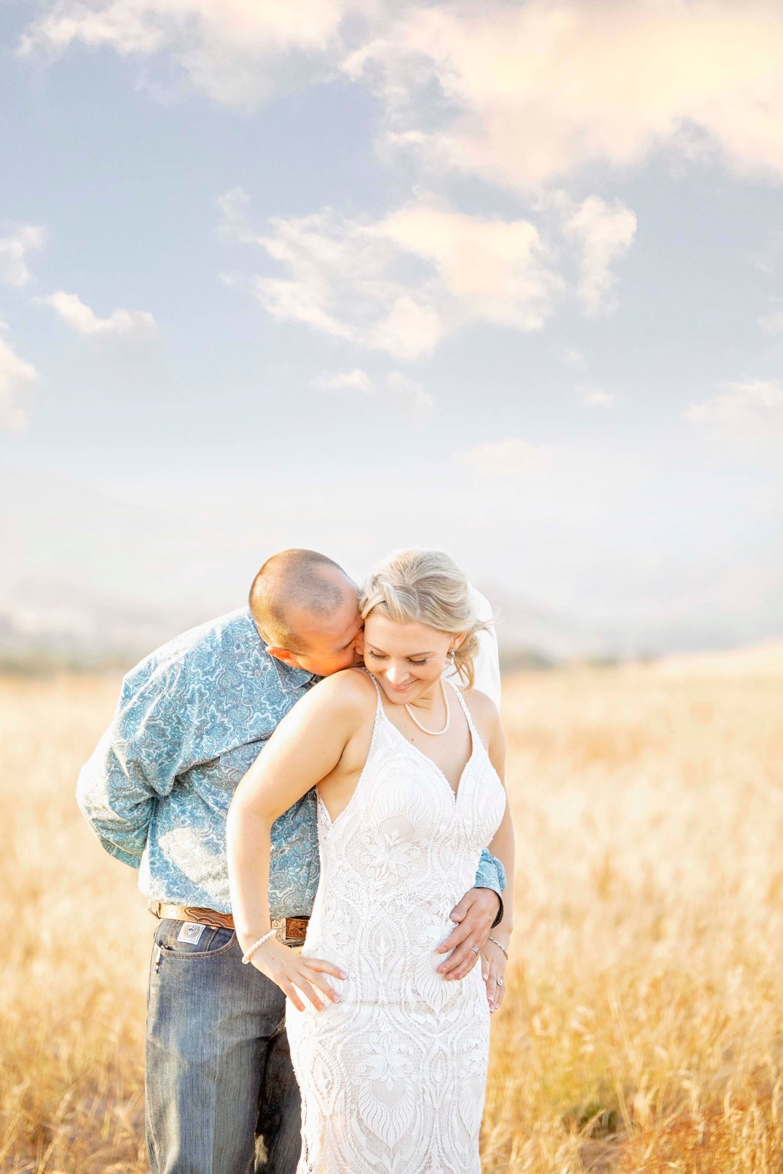 bride and groom in a grassy field
