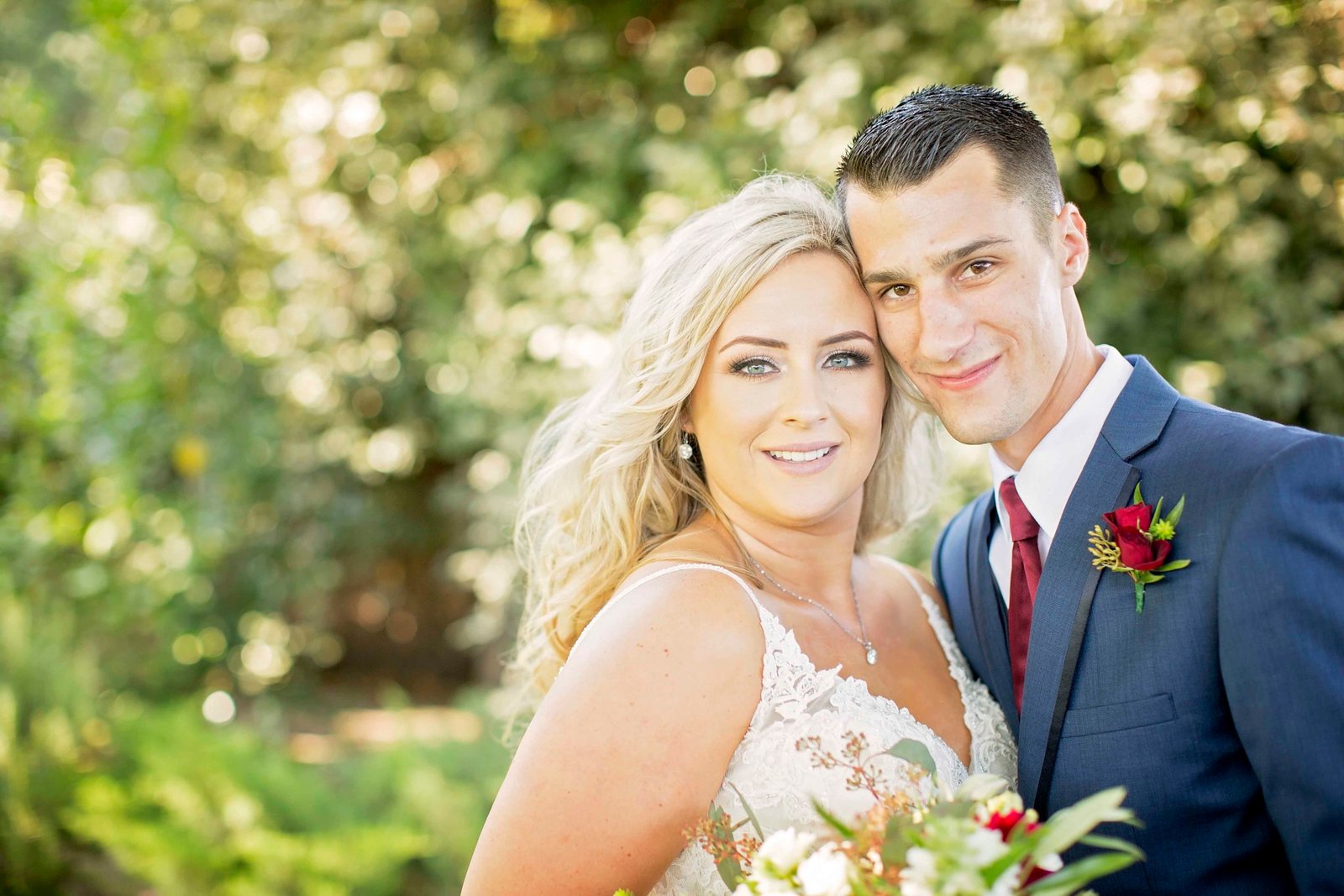 Bride and groom with heads together looking at the camera at The Loading Chute