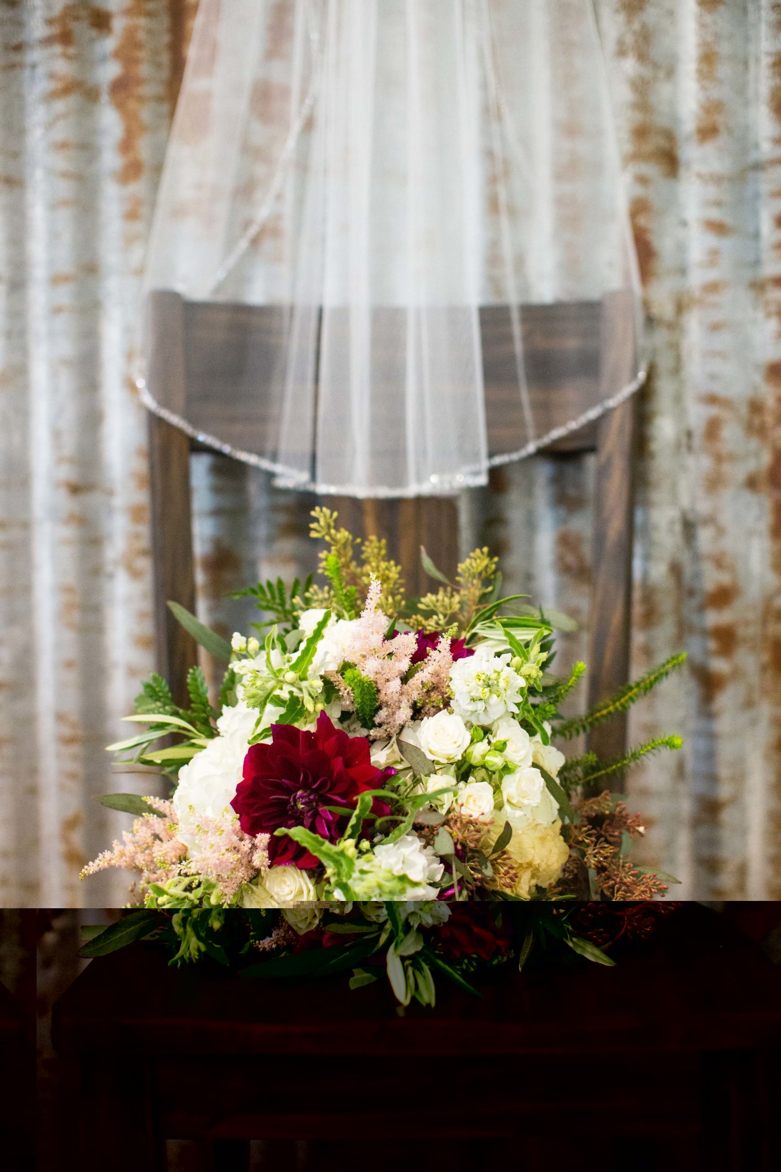 Wedding bouquet on a chair in front of a tin wall at The Loading Chute