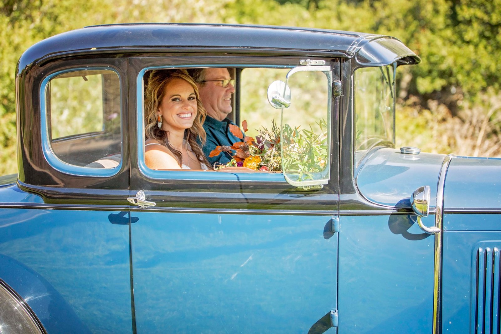 Bride looking out the window of a classic Ford Model A at Loma Grande Ranch