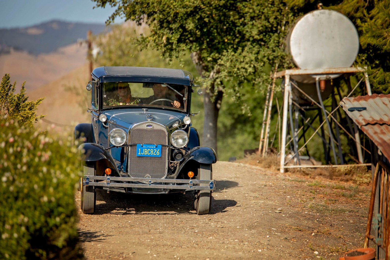 Bride arriving in grooms classic car at Loma Grande Ranch