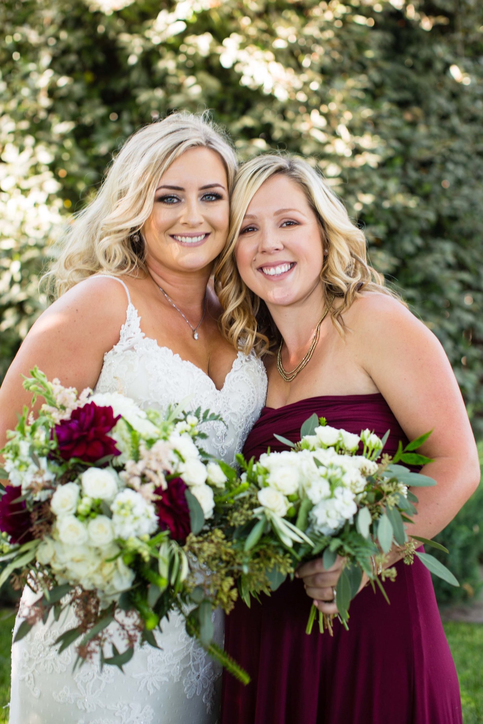 bridesmaid and bride pose for a portrait at The Loading Chute