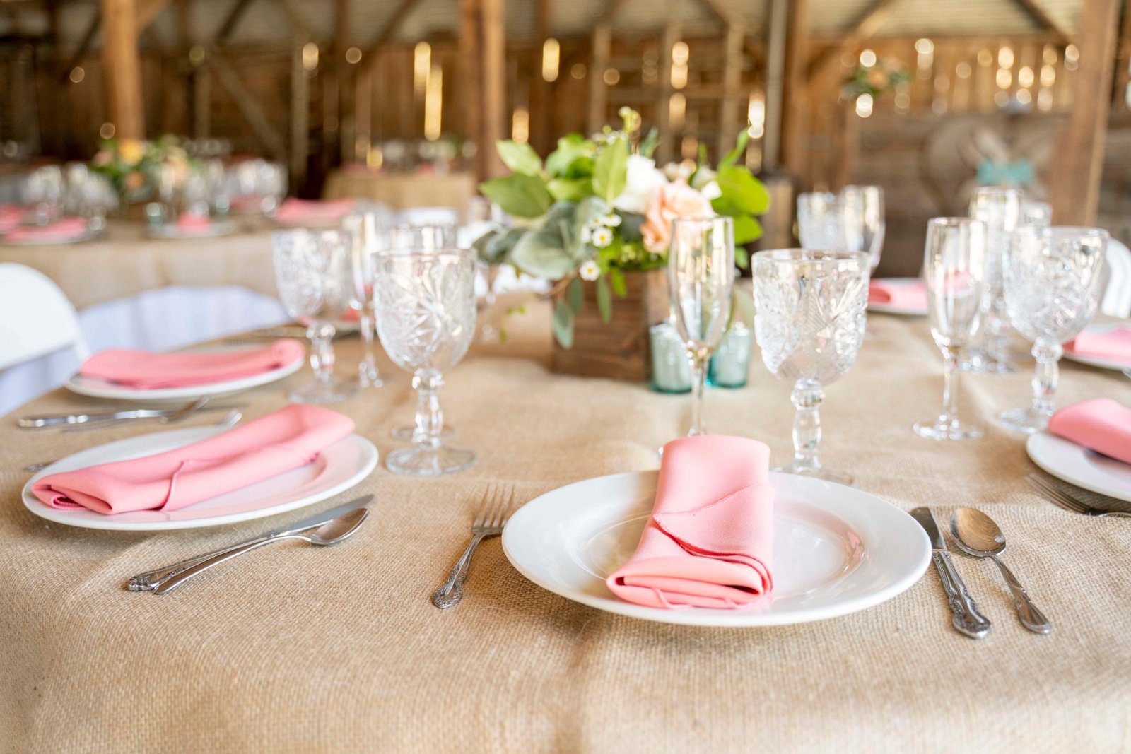 Table setting with pink linen napkins for a wedding reception at Loma Grande Ranch