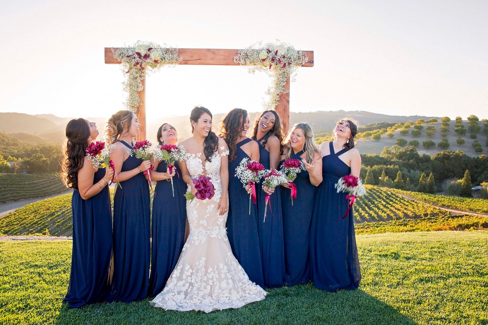 Bride laughing with bridesmaids on the hilltop at Opolo