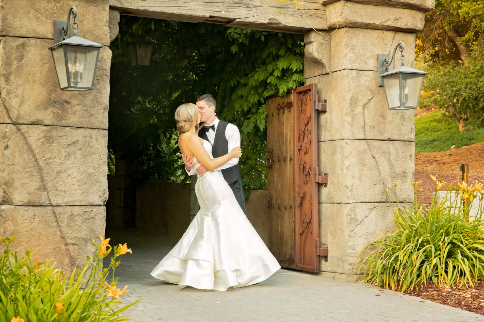 bride and groom kissing in a doorway