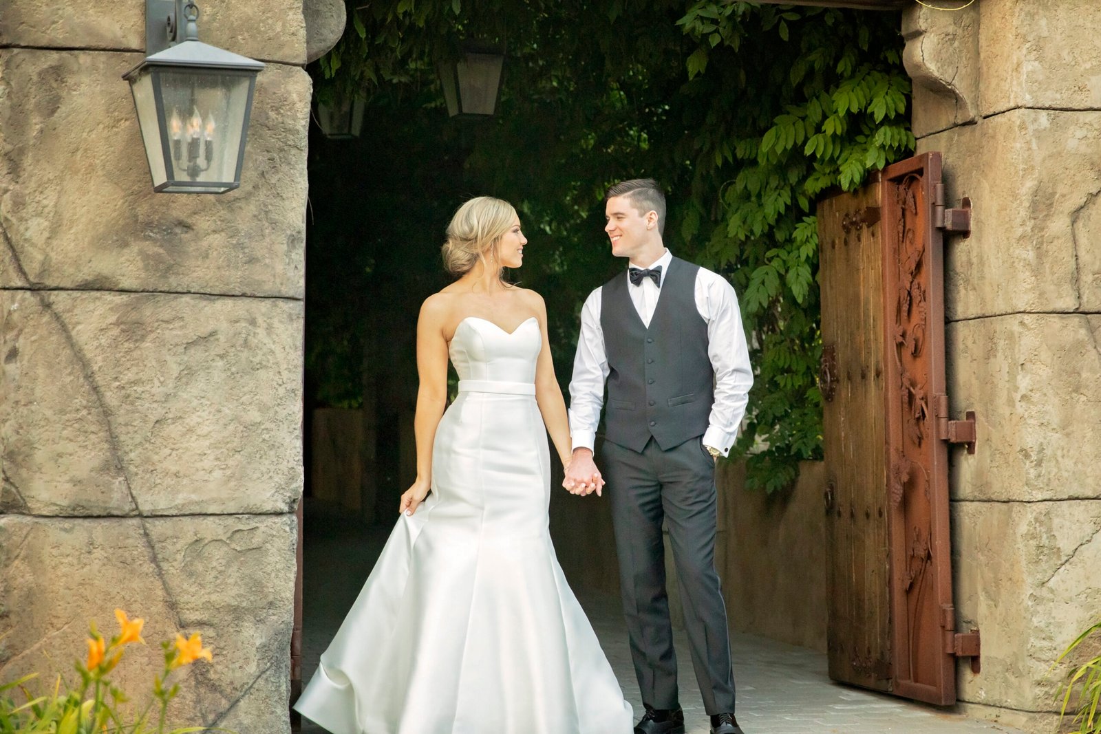 bride and groom looking at each other in front of a doorway at villa loriana