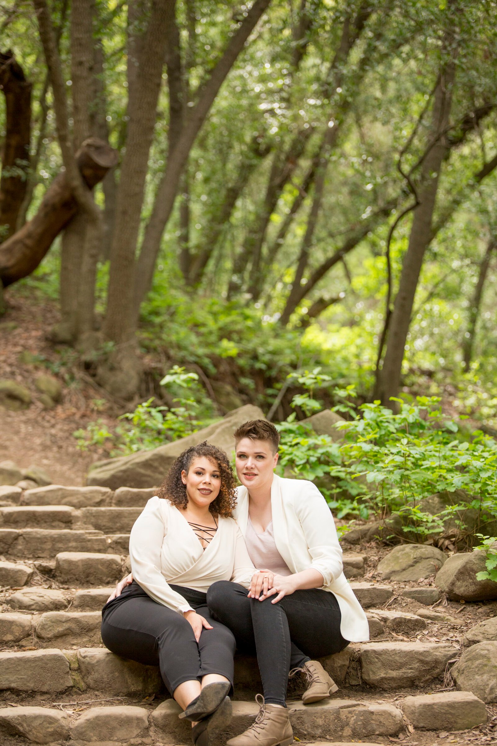 two women sitting on stone steps on the trail to Nojoqui Falls
