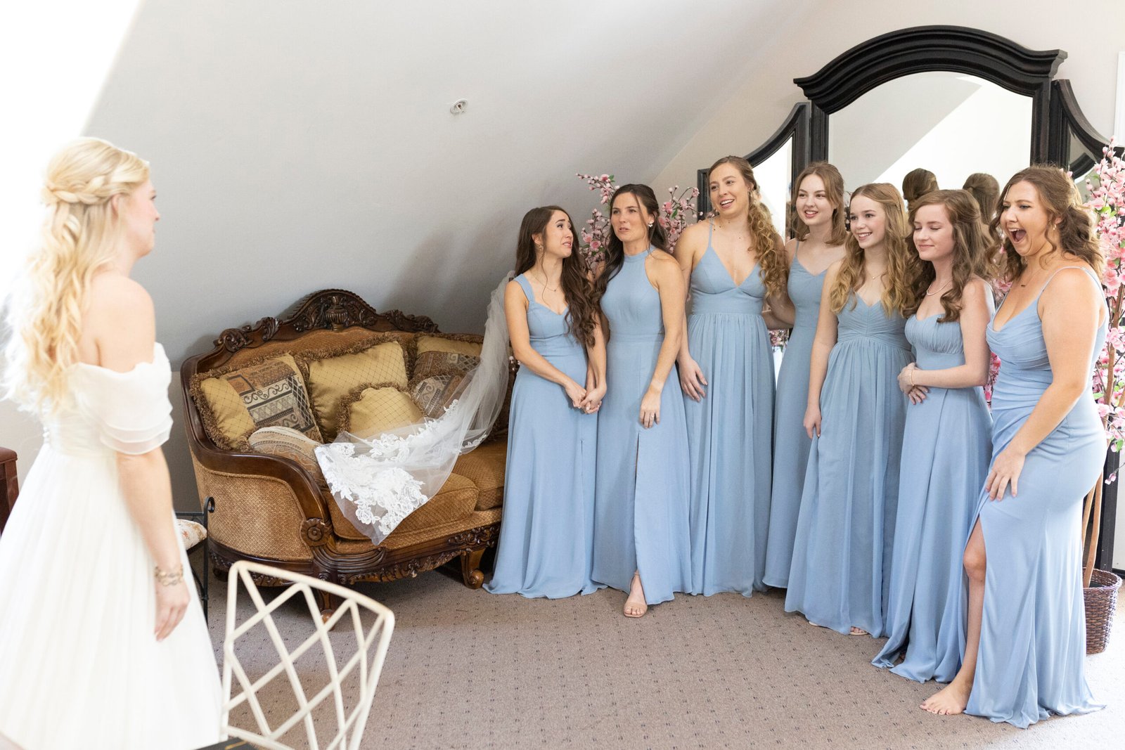 bridesmaids see the bride for the first time in her dress
