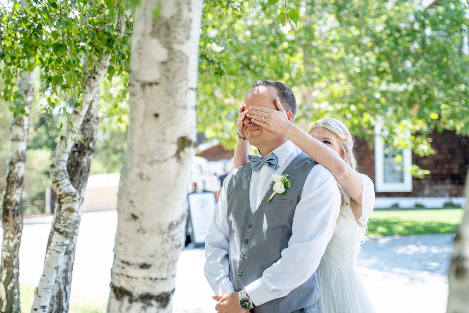 bride covering grooms eyes for the first look