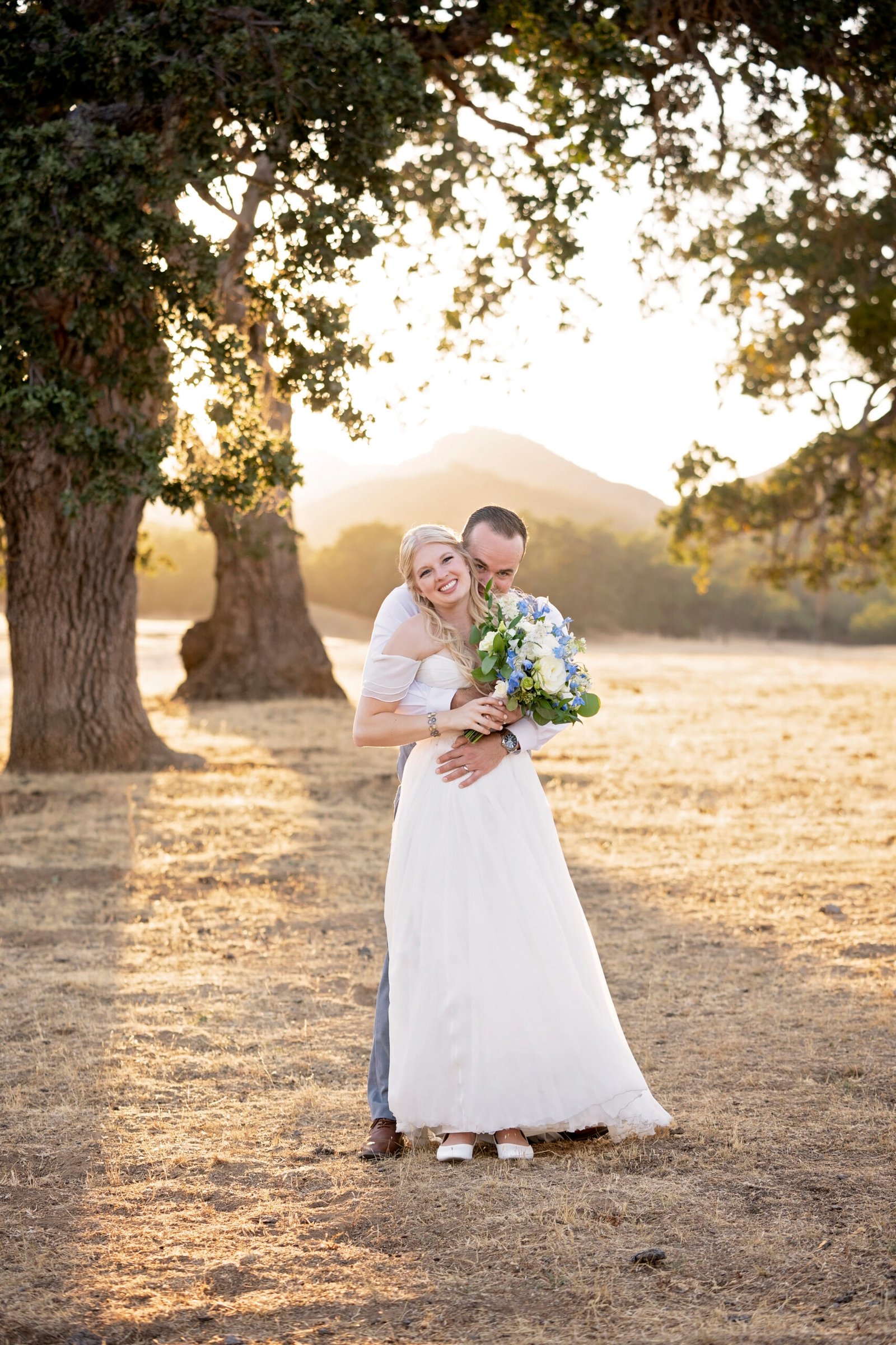 bride and groom in an open field at Spanish Oaks Ranch