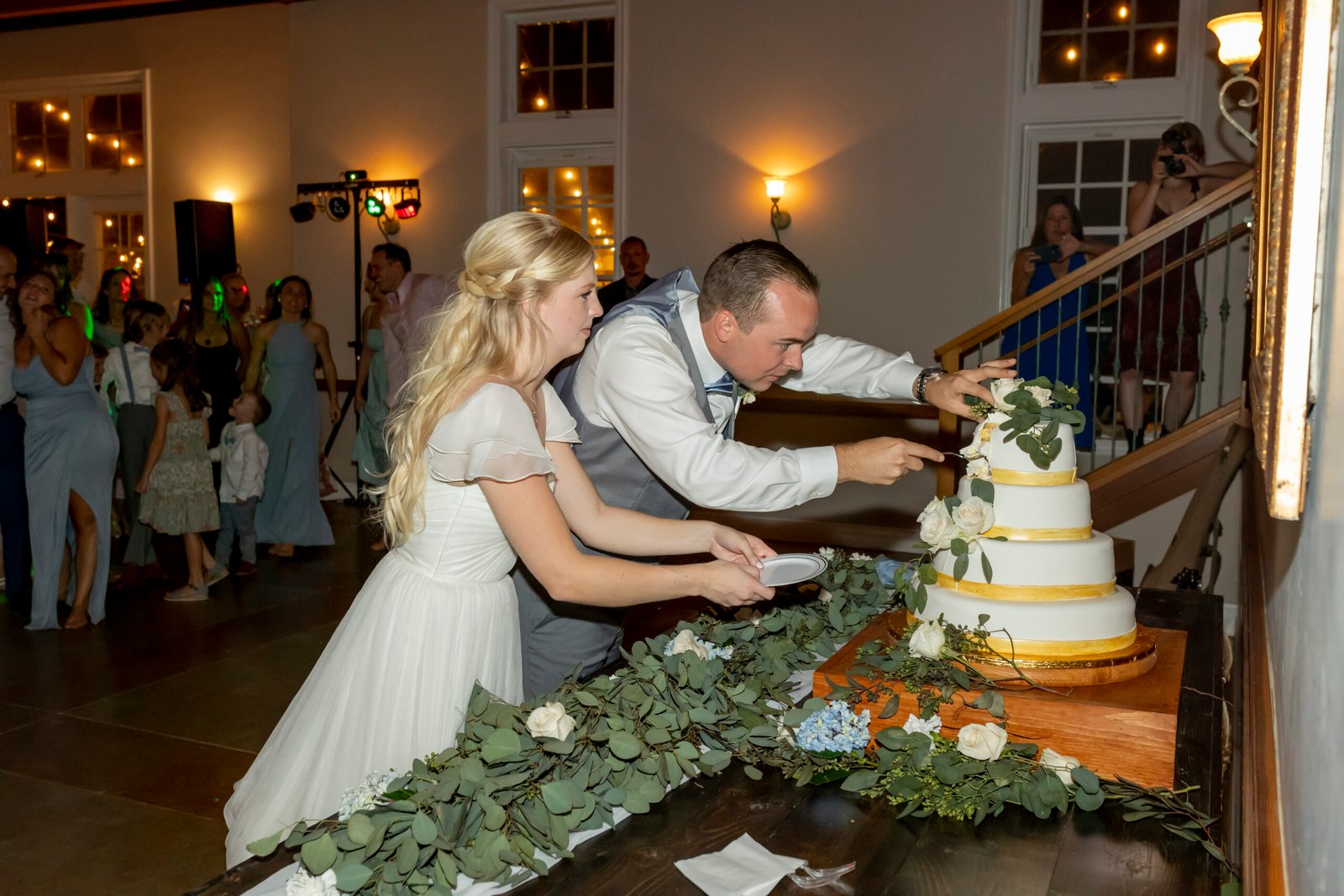 bride and groom cutting the wedding cake