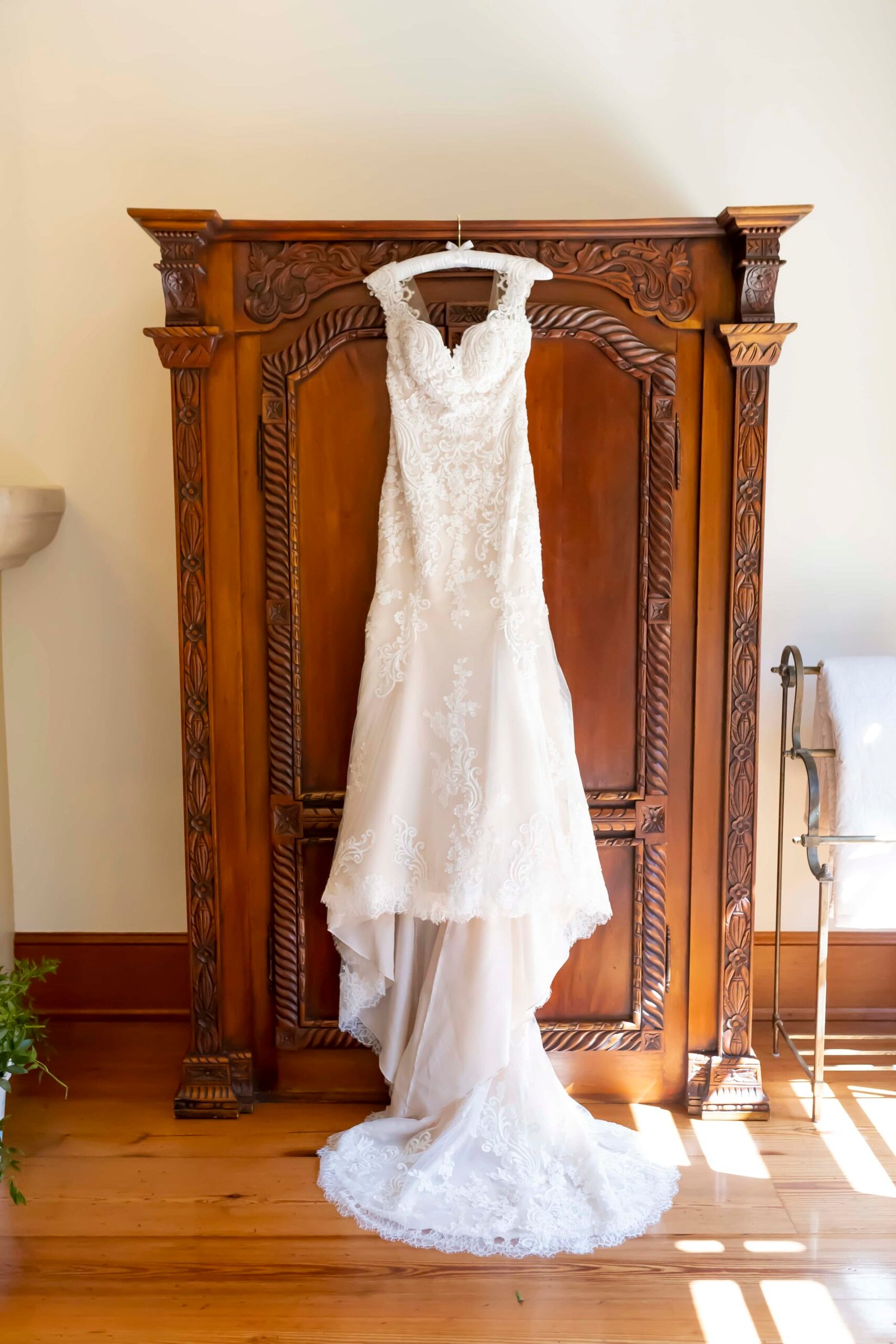 wedding dress hanging on an armoire at CaliPaso Winery in the winemaker's suite