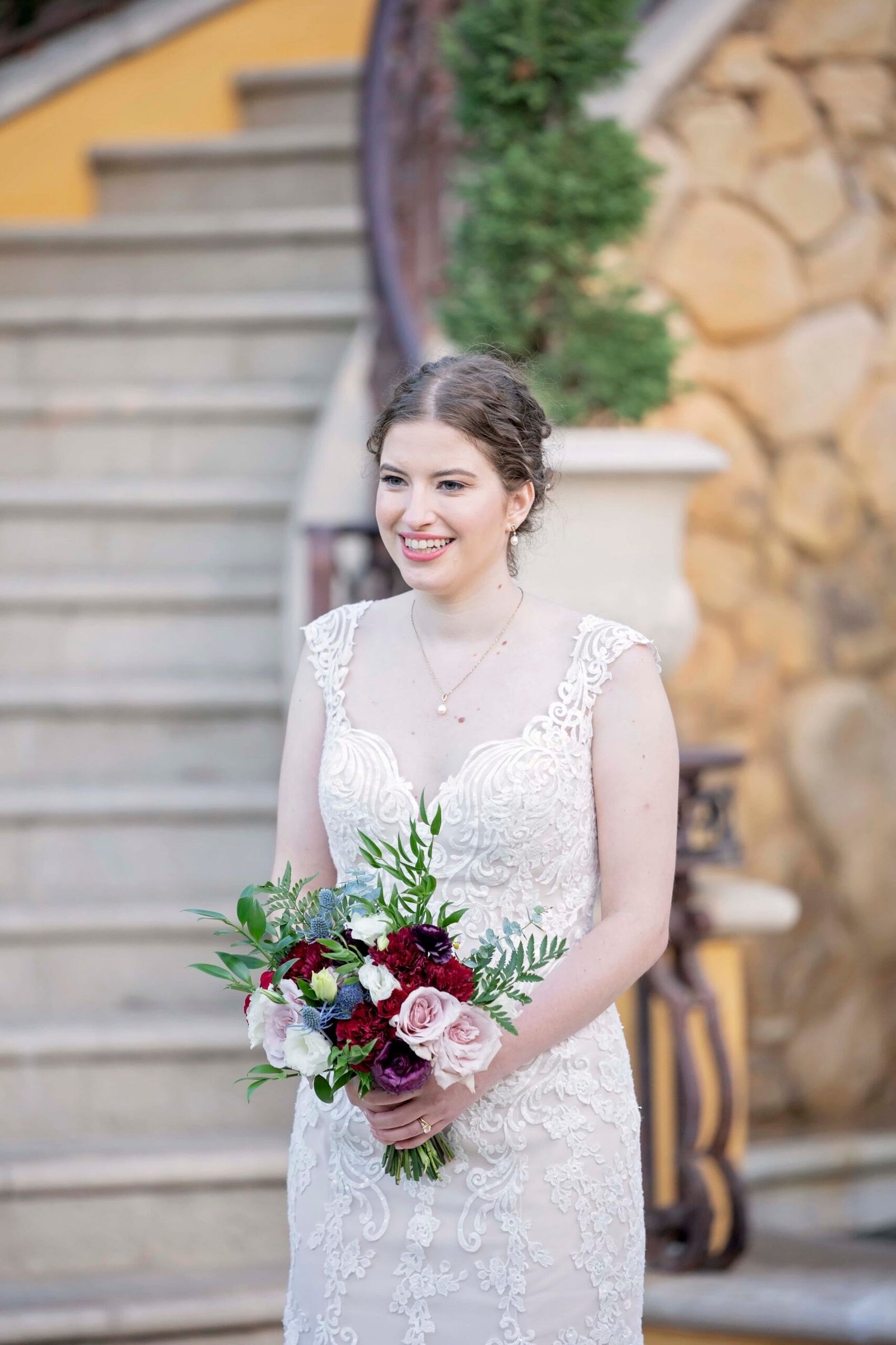 bride holding her bouquet and smiling at the camera