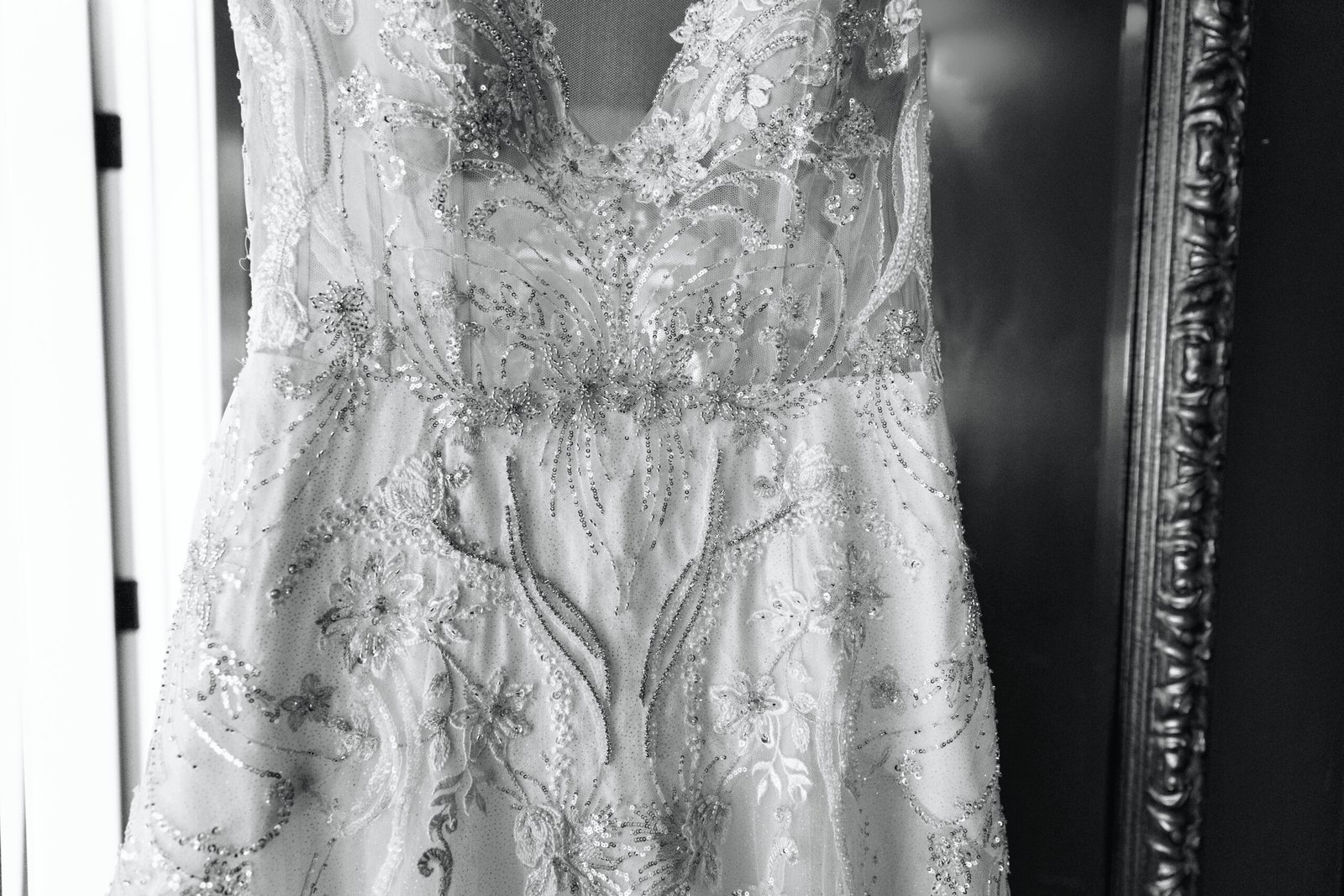 black and white photo of a wedding dress with intricate beadwork