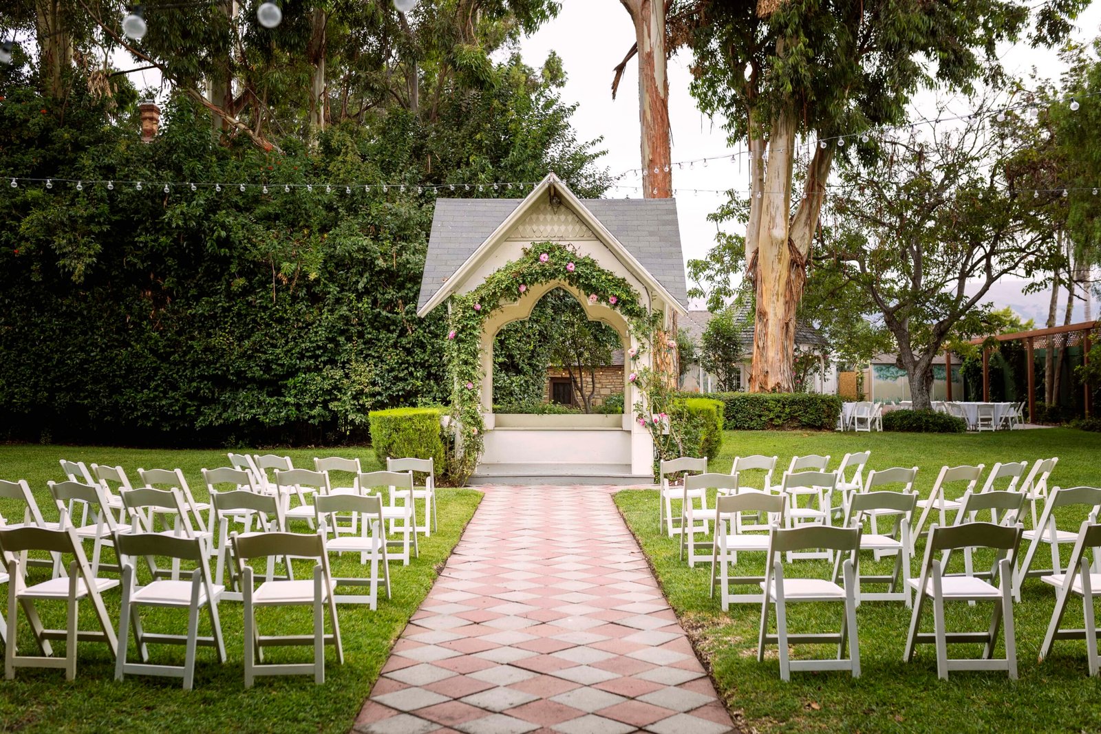 Wedding ceremony gazebo with roses growing on the arch