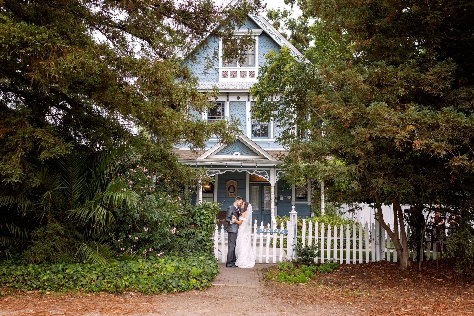 Bride and groom embrace in front of the Kaleidoscope Inn