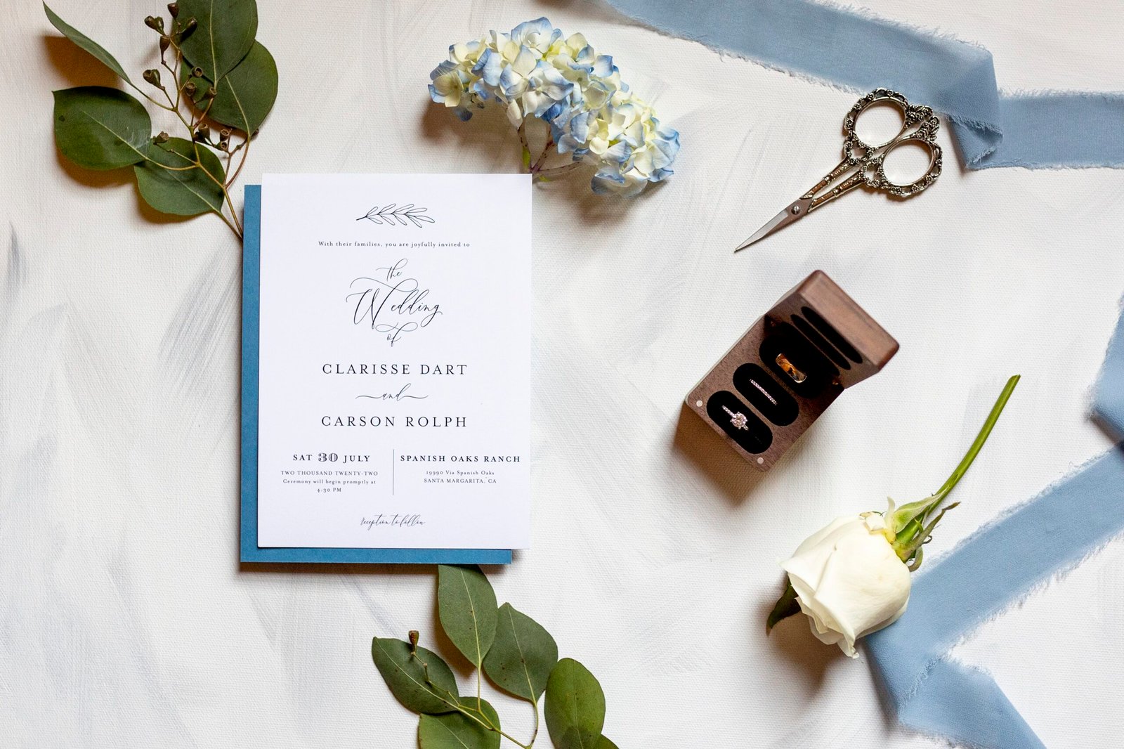 wedding invitation with flowers and greenery