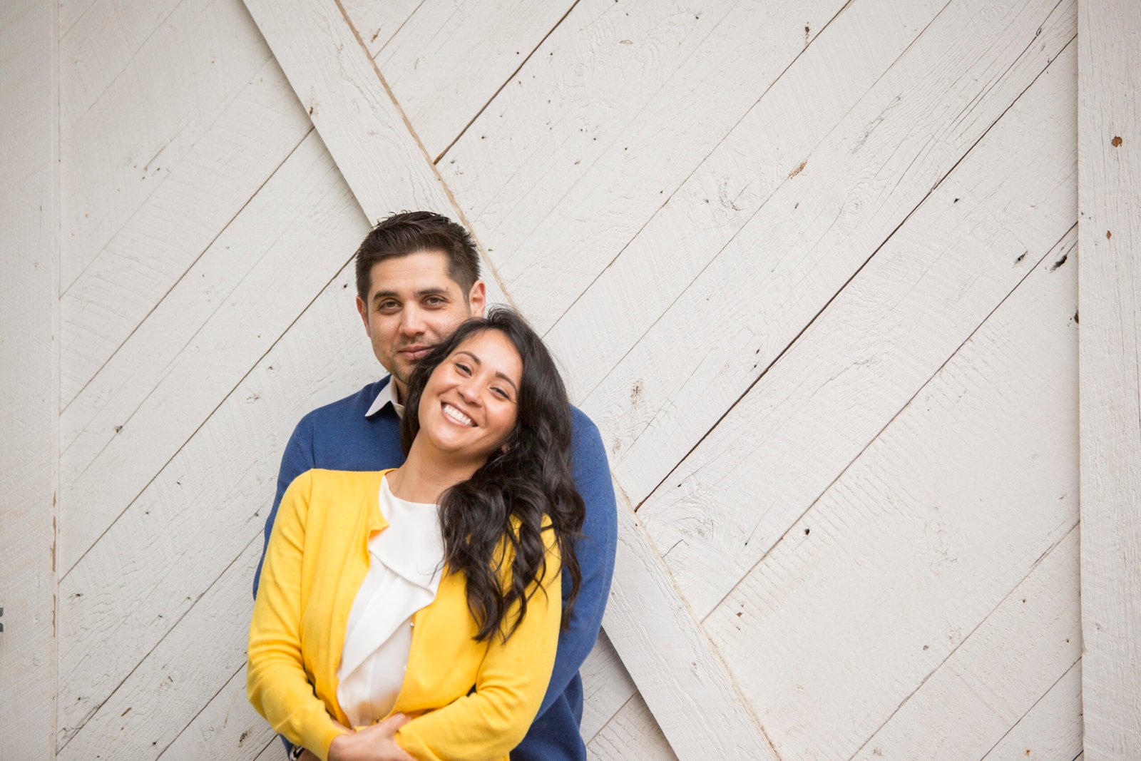 couple smiling at the camera during an engagement session