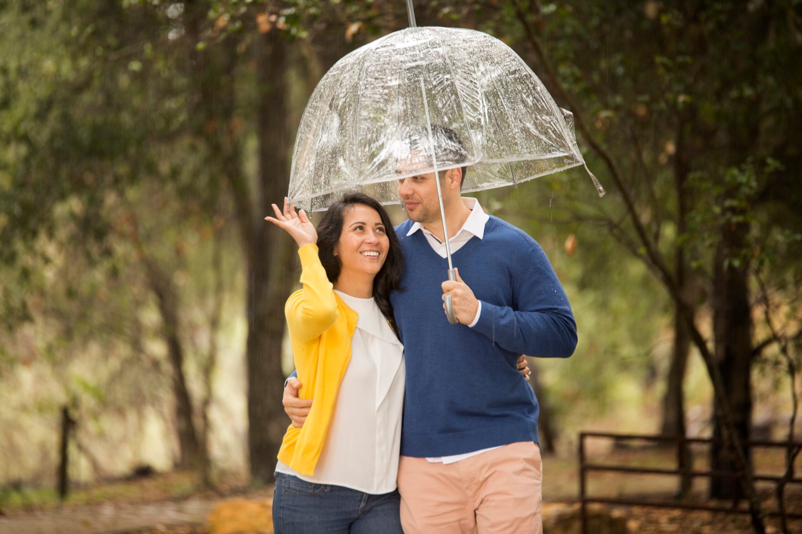 couple walking together under a clear umbrella