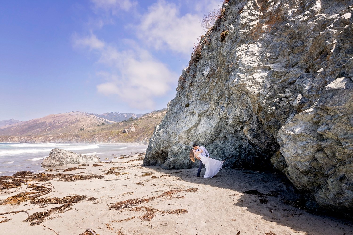 groom dipping the bride on a beach in Big Sur