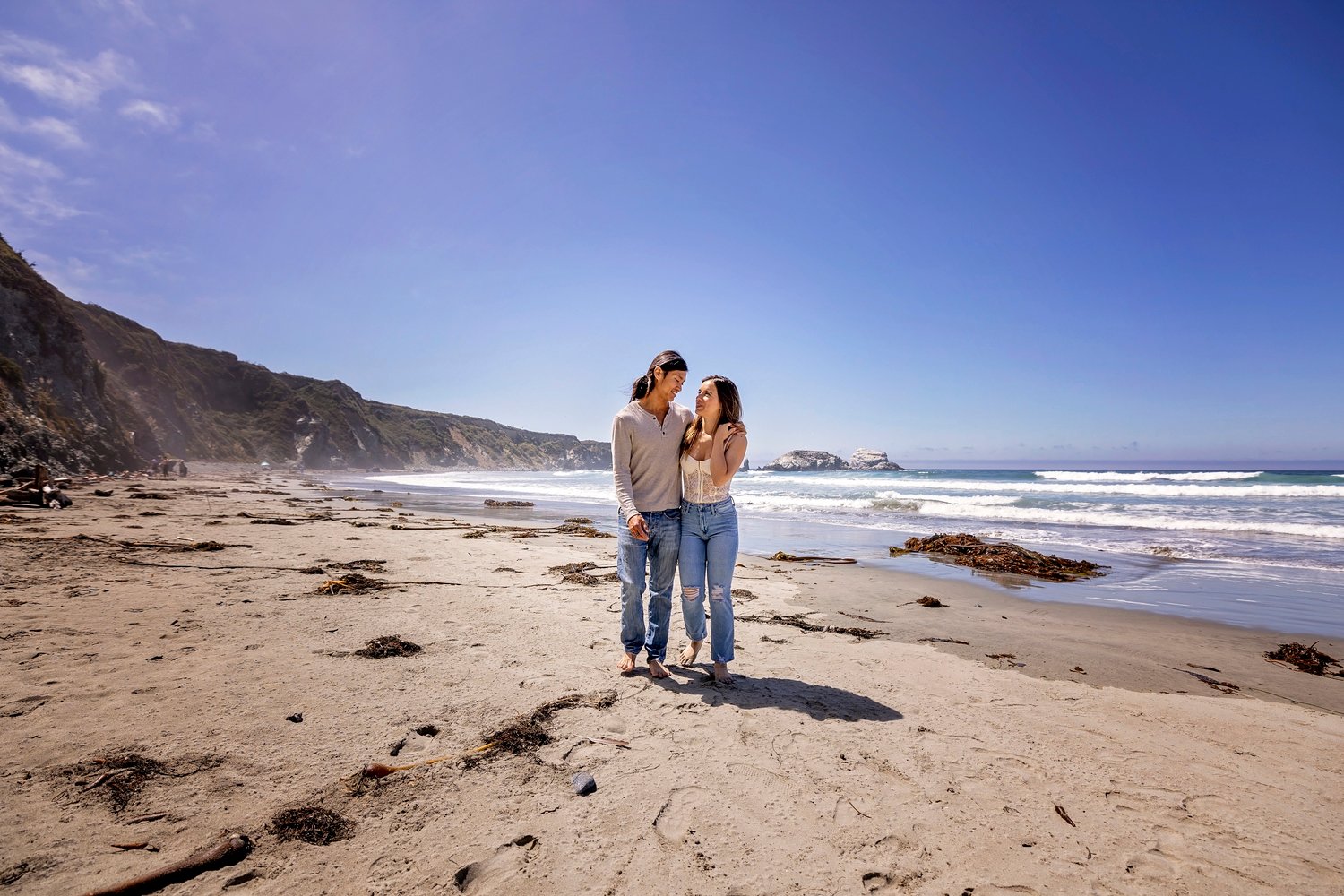 couple walking along the beach during an engagement session