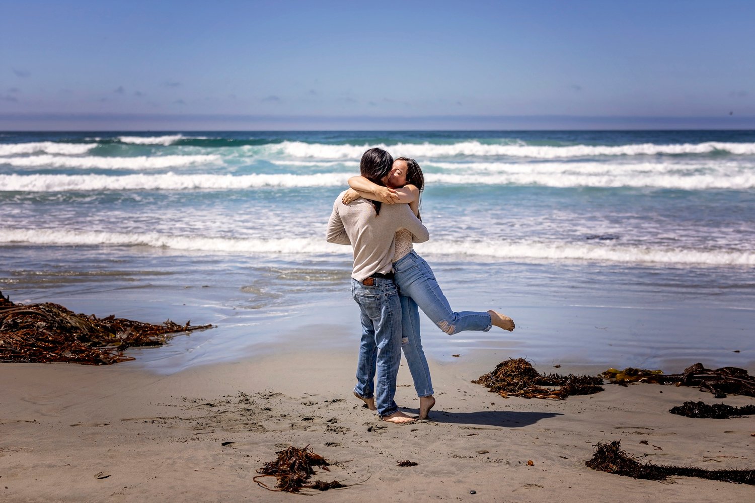 Couple dancing on the beach during an engagement session