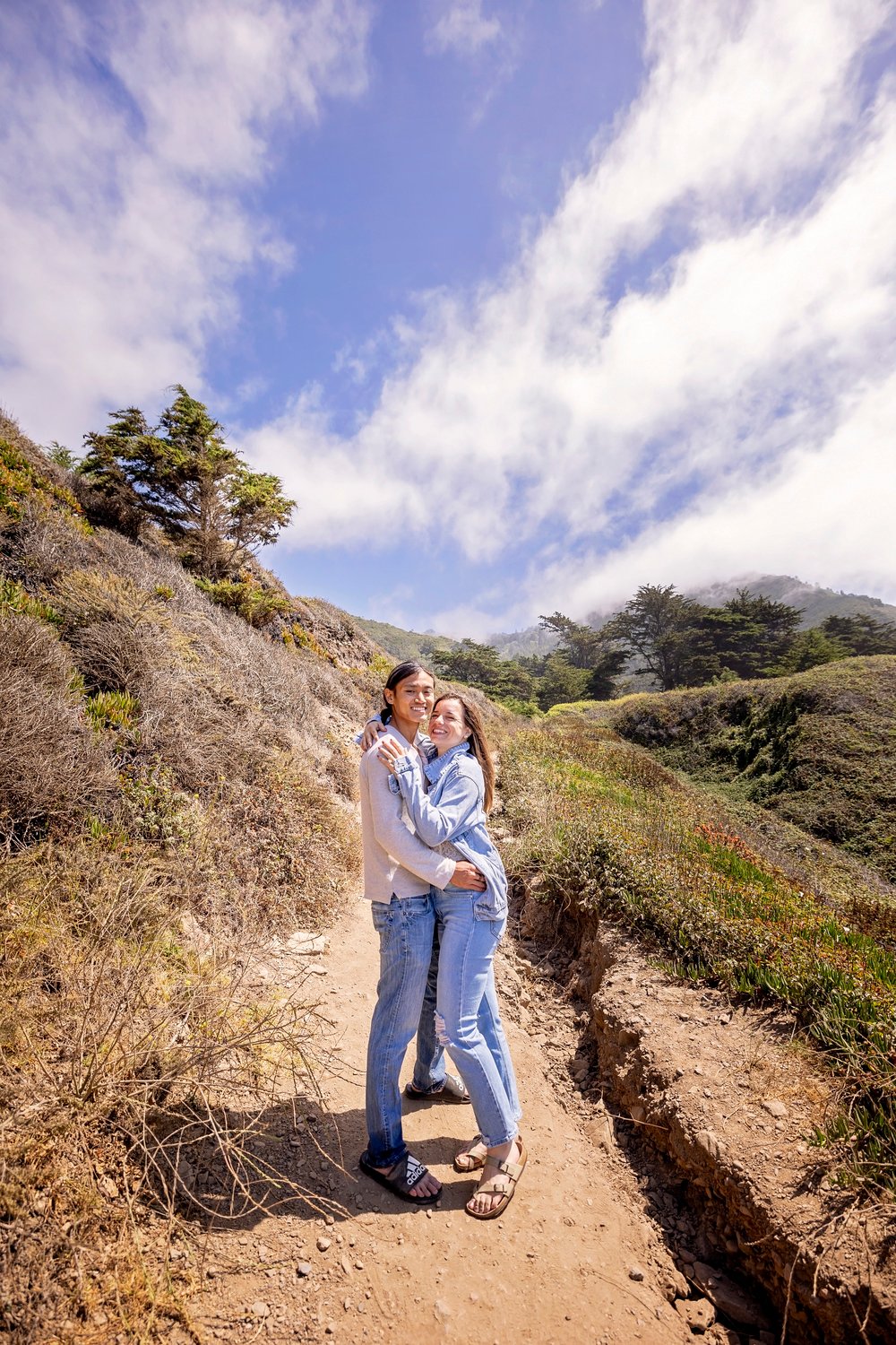 couple standing together on a dirt path at Sand Dollar Beach