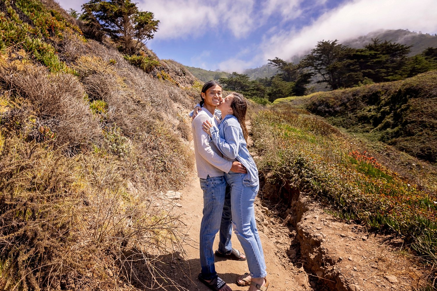 couple standing together on a dirt path in Big Sur
