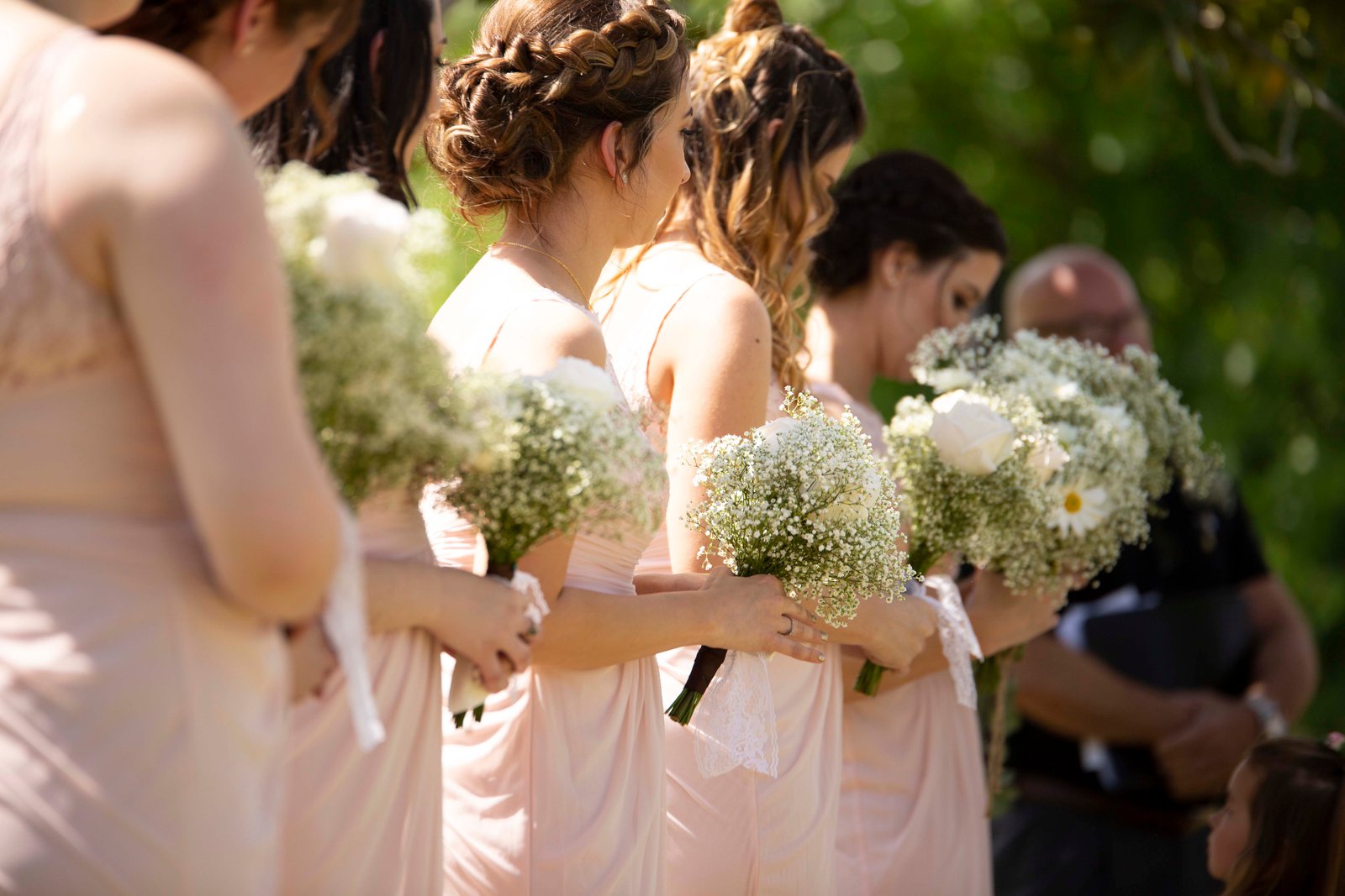 Bridesmaids holding bouquets of baby's breath
