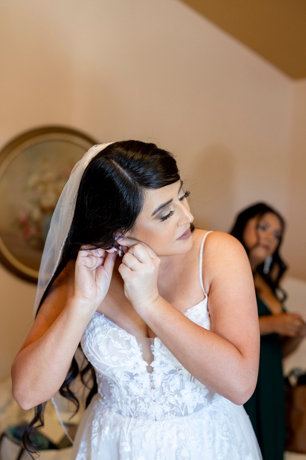 bride putting in her earrings