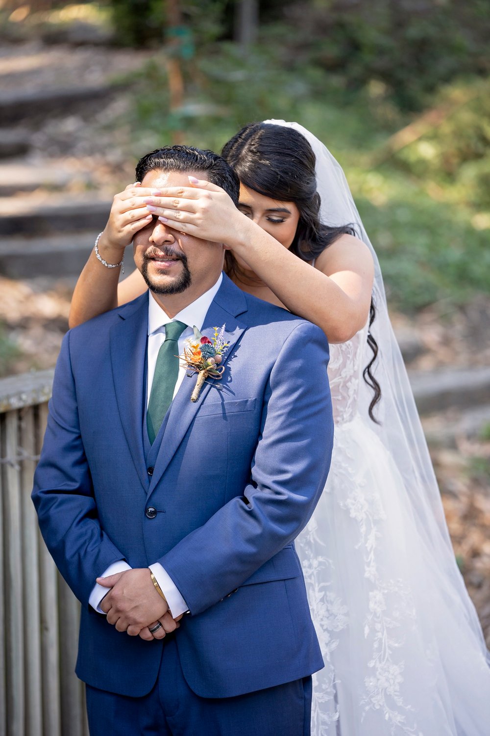 bride covering the groom's eyes for the first look